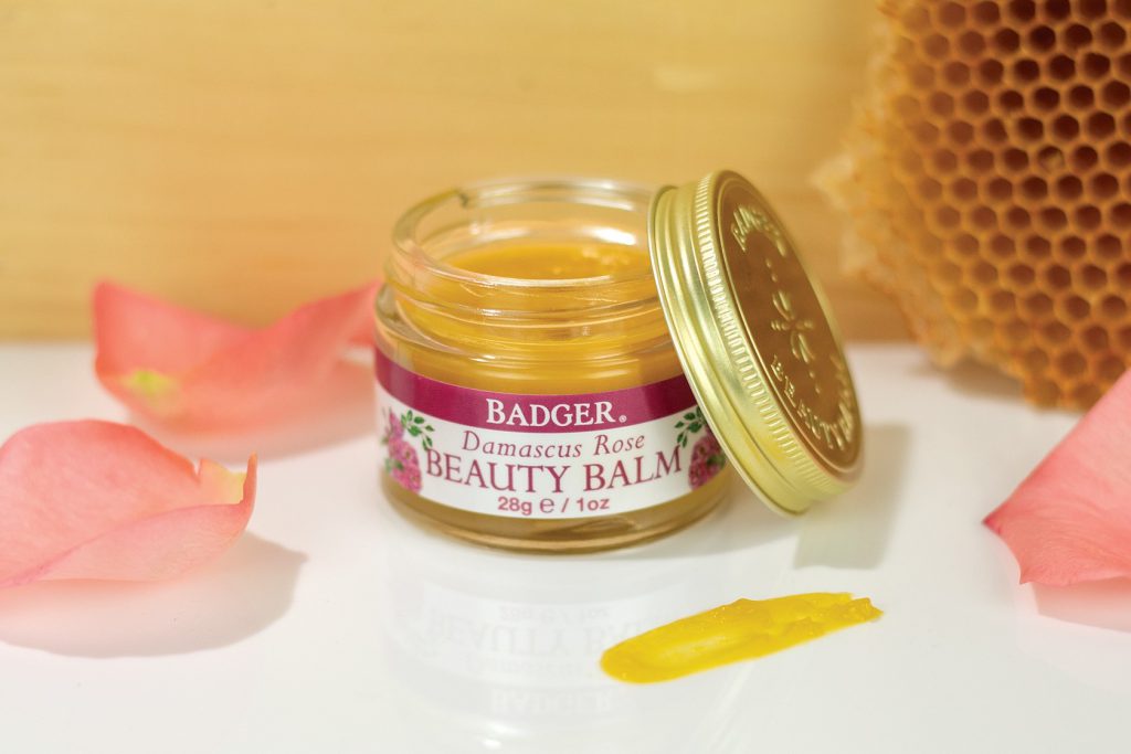 Rose Beauty Balm surrounded by beeswax and rose petals.