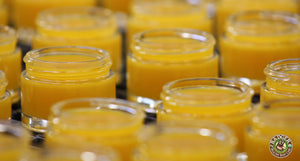 Badger Argan Beauty Balms freshly filled on the line. The color is a sunny golden